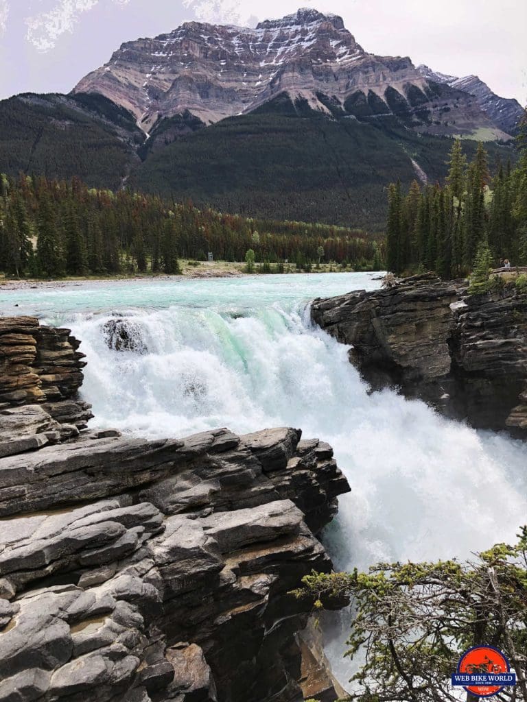 A waterfall with interesting rock formations surrounding it.