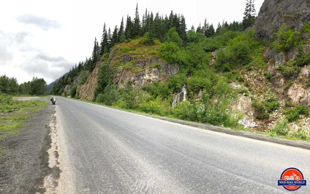 The high rock walls covered with trees and bushes.