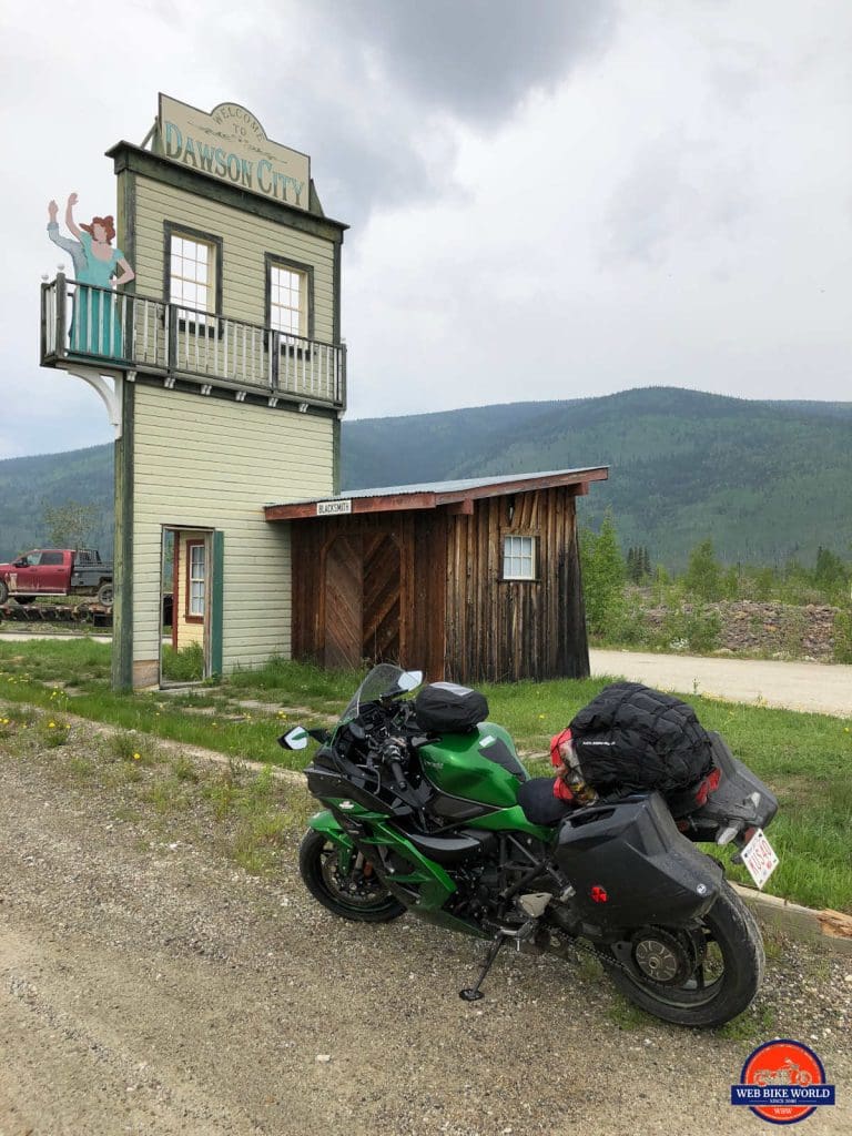 The welcome sign for Dawson City and my ninja H2SX SE.