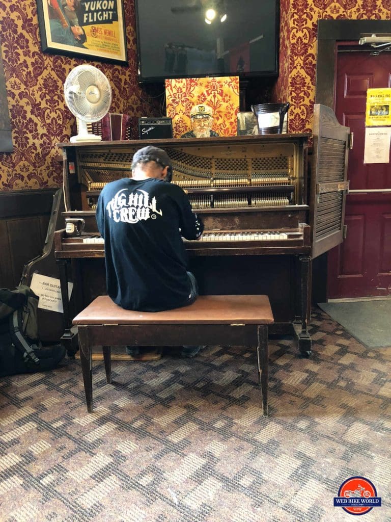 Dwayne Kelly playing the piano in the Sourdough Saloon.