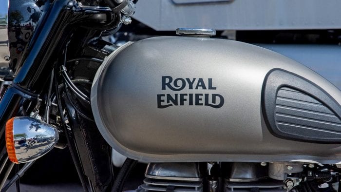 The Royal Enfield brand name painted on a gas tank.