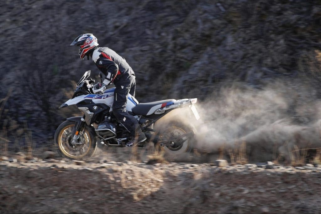 BMW adventure motorcycle riding on a dirt trail