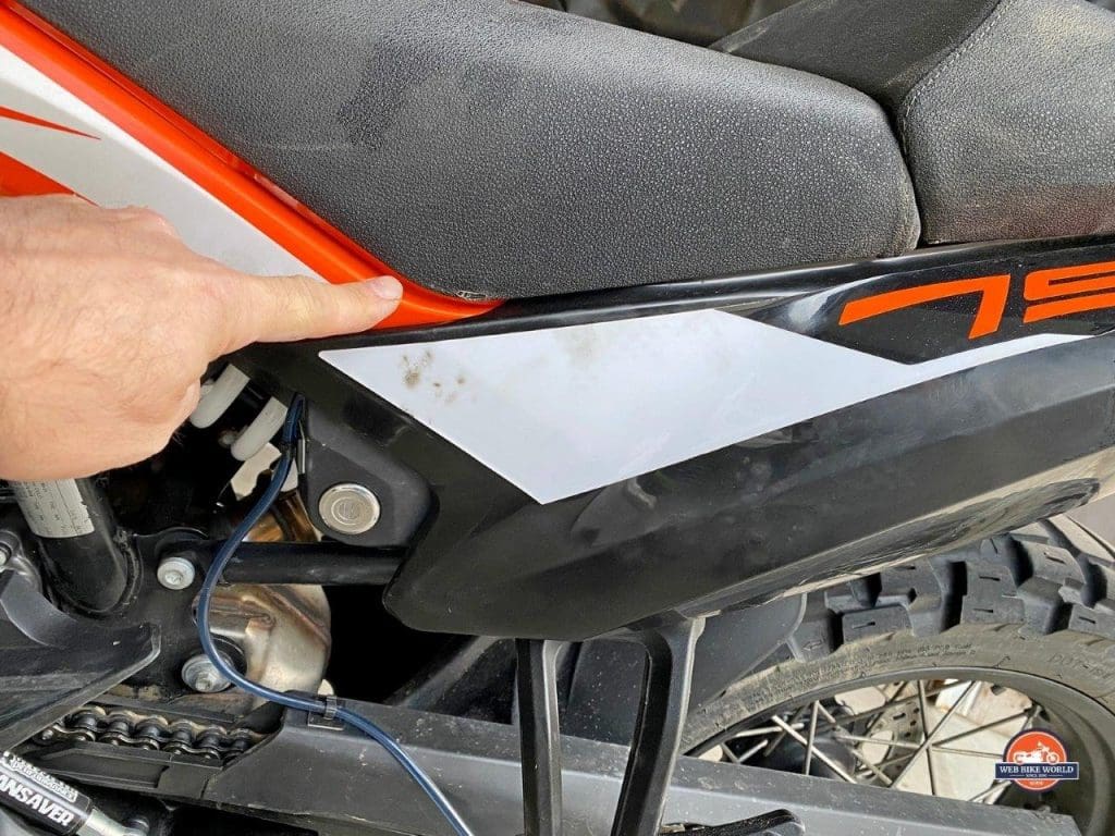 A rubbed through seat cover on my KTM 790 Adventure due to a poorly routed strap from the Mosko Moto Reckless 80L V3.0 Revolver.