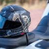 The new Shoei RF-1400 helmet sitting on a Harley Davidson seat.