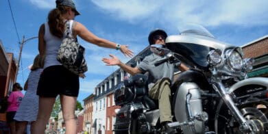 A view of a rider joining hands with a grateful civilian in commemoration of America's 911 Foundation Ride