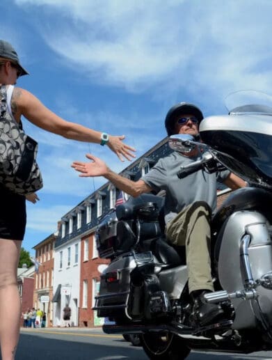 A view of a rider joining hands with a grateful civilian in commemoration of America's 911 Foundation Ride