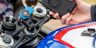 A rider on a BMW motorcycle, trying out the Quad Lock phone mount