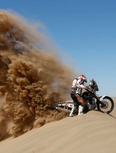 A rider racing in an enduro event similar to the 2021 Morocco Rally or the Dakar Rally