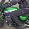 Rider wearing Richa Softshell WP Pants on green Kawasaki motorcycle