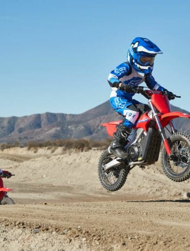 A young rider riding the dirt on a CRF-E2