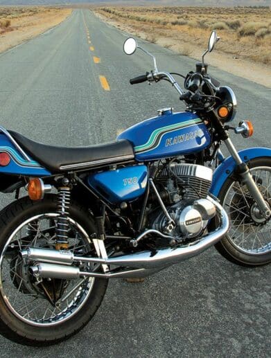 A 1972 kawasaki H2 MkIV motorcycle on a desert road at sunset in America