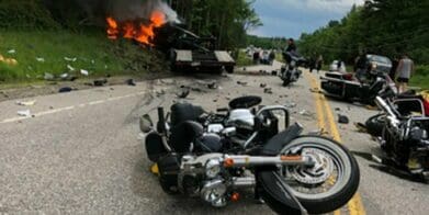 A view of a crashed motorcycle and truck accident.