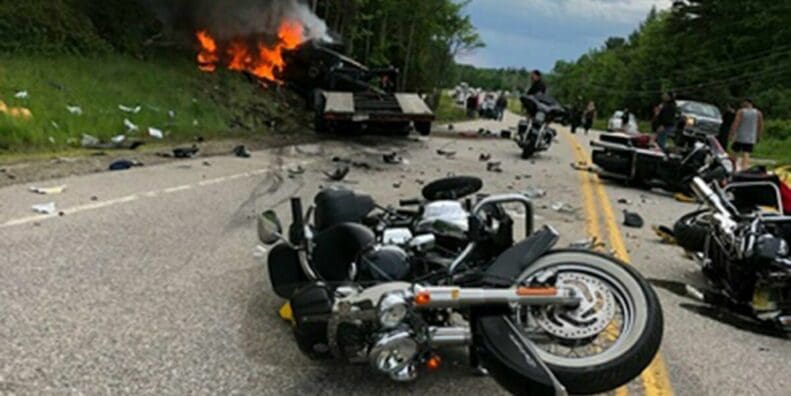 A view of a crashed motorcycle and truck accident.