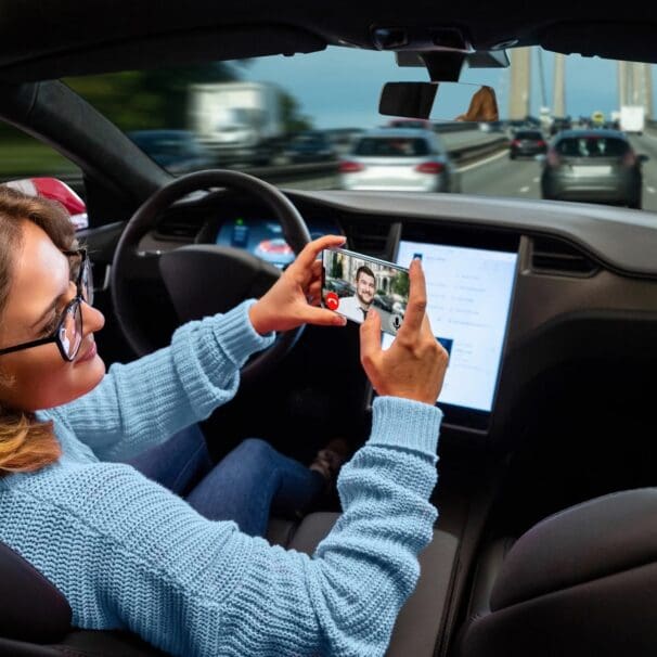 A self-driving owner looking at their screen. Media sourced from The Guardian.