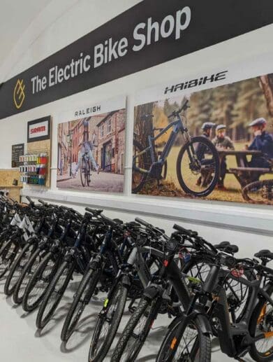 Row of Haibike and Raleigh electric bike models in store