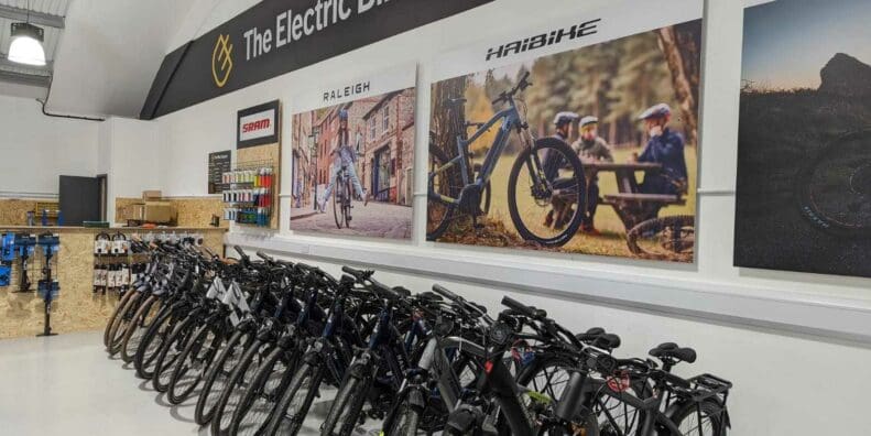 Row of Haibike and Raleigh electric bike models in store