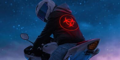 A biker with a biohazard sign on their hoodie. Media sourced from Rare Gallery.