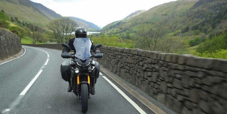 A motorcyclist enjoying cost-per-mile insurance - currently onyl a thing in the UK. Media sourced from VisorDown.