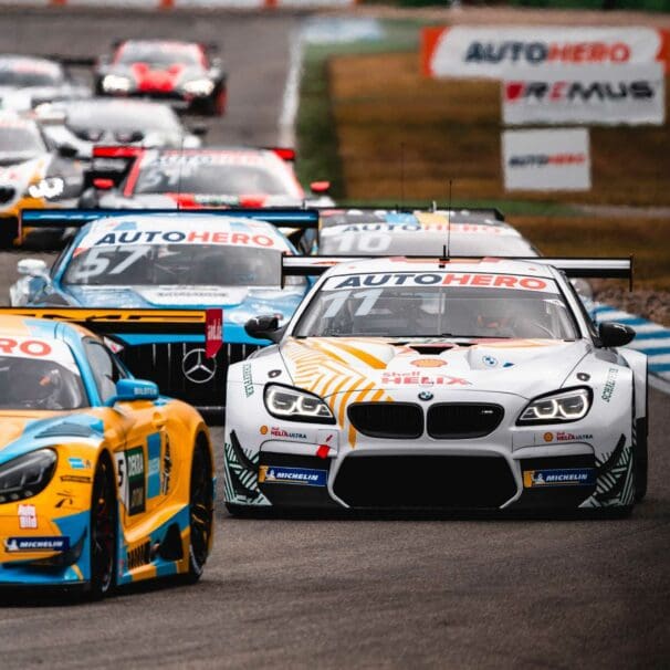 BMI and Audi race cars drive around track during championship division