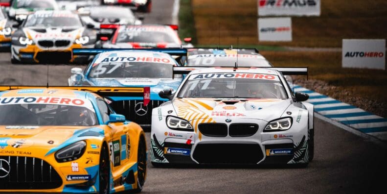 BMI and Audi race cars drive around track during championship division