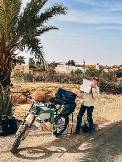 Sinje Gottwald, CAKE’s sales/account manager, beside a Kalk as she breaks a new record for "longest distance ever on an electric motorcycle." Media sourced from CAKE's Facebook page.