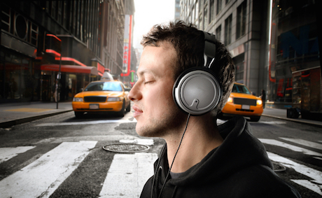 Pedestrian wearing headphones earphones