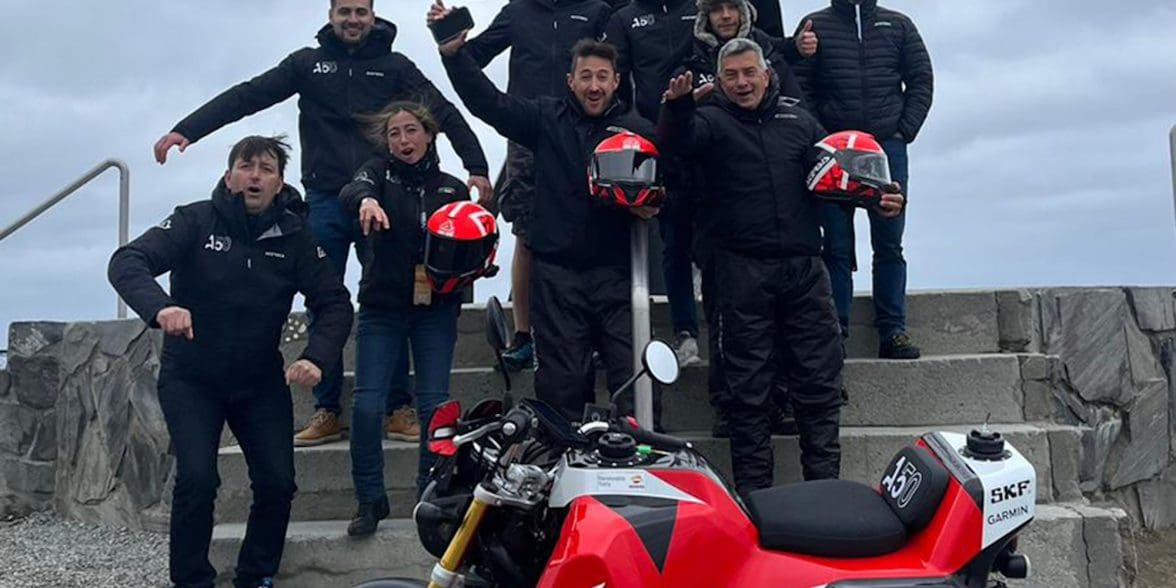 A view of the Acerbis team and their Honda Monkey, featuring a massive gas tank. Media sourced from Superbike News.