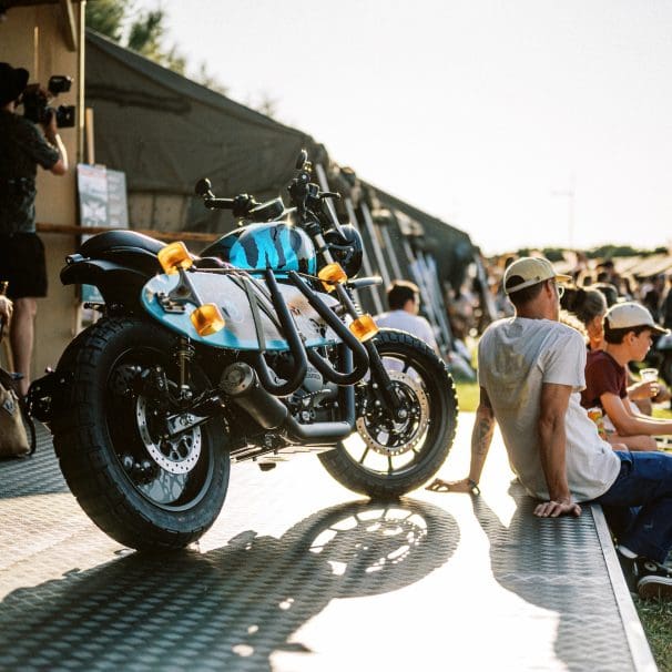 a motorcycle and visitors at the 2023 Wheels & Waves Bike Show in Biarritz, France