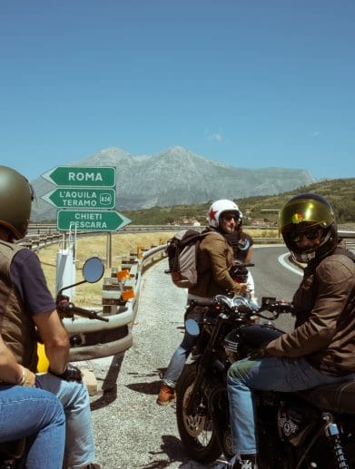 motorcyclists stop a fork in the road near Abruzzo outside of Rome.