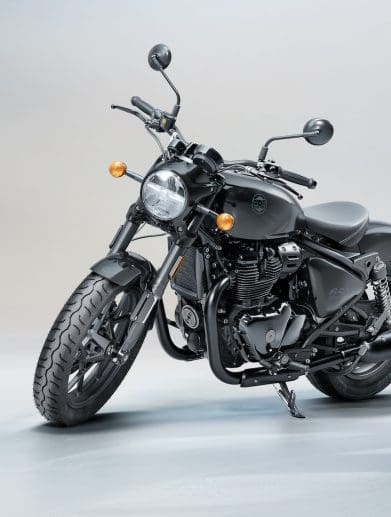 A side quarter view of a Royal Enfield motorcycle in a studio setting.