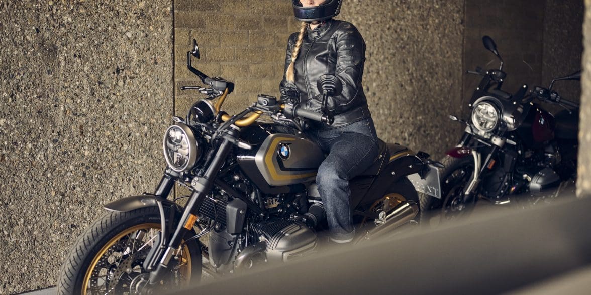 A woman sitting on a motorcycle.