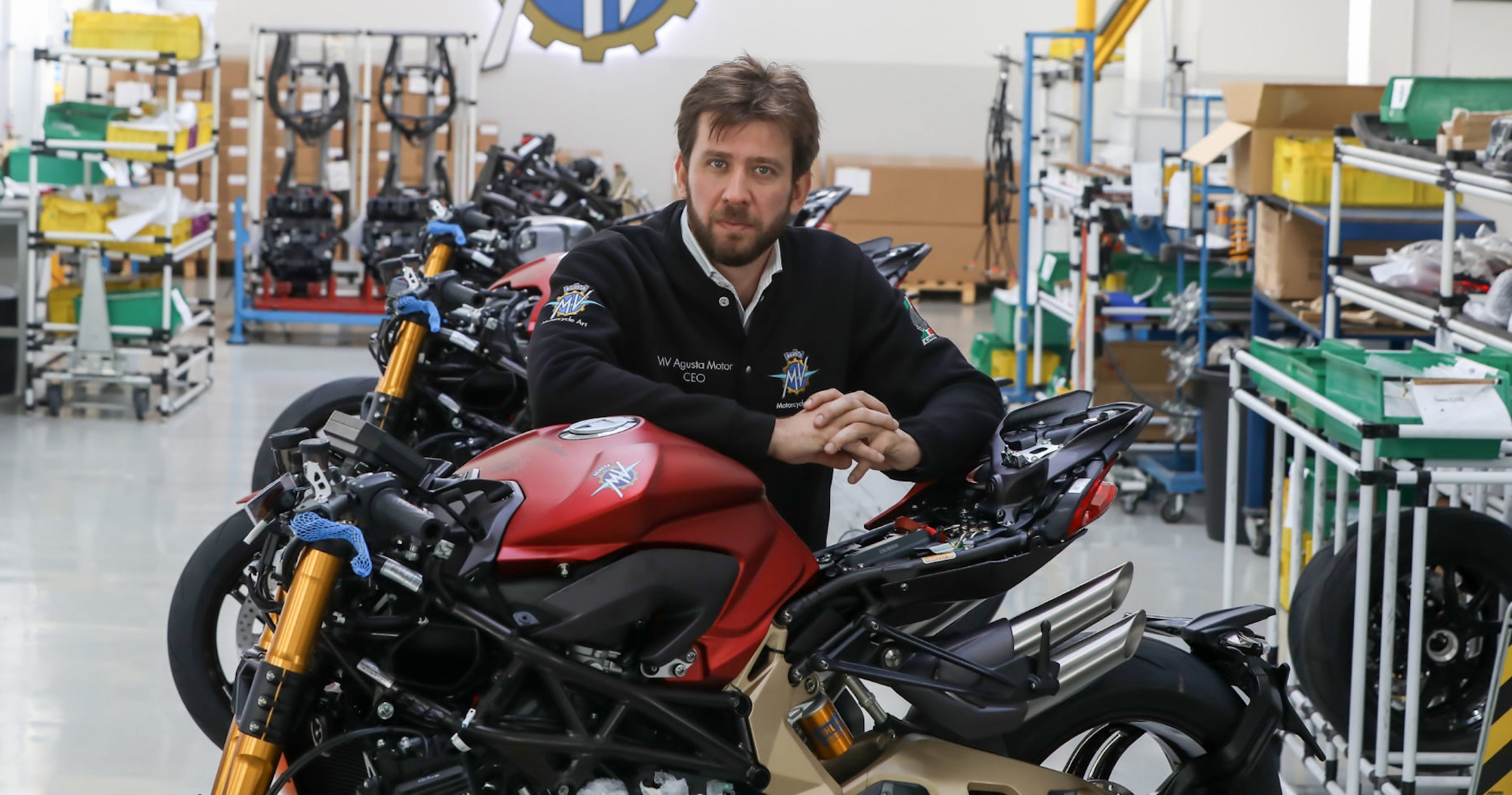 A motorcycle company founder with his motorcycles.