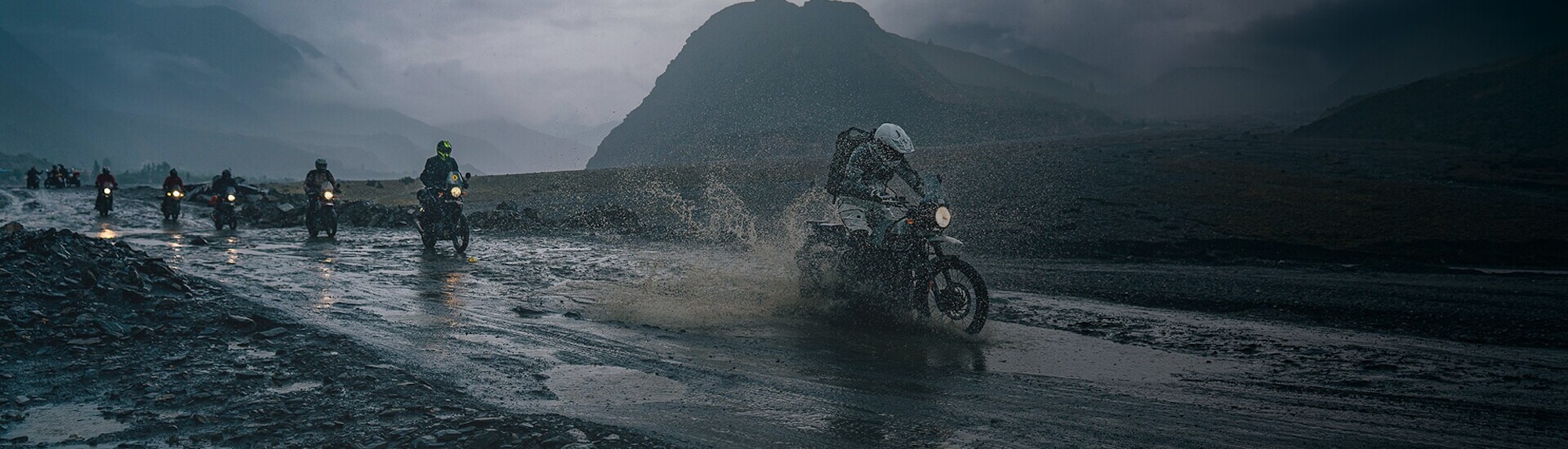 A picture of motorcyclists riding in the Himalayas. 