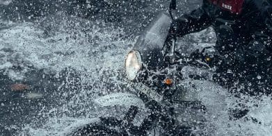 A view of a motorcyclist in water.