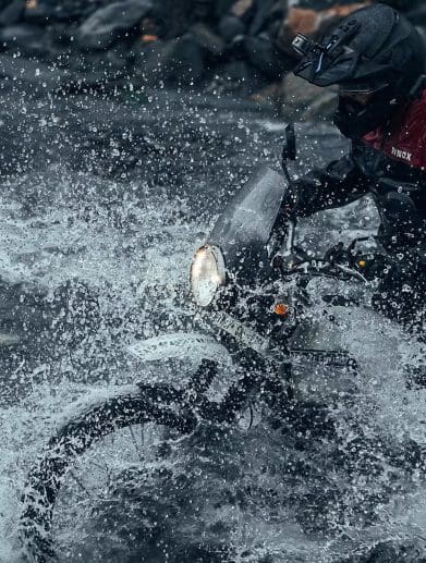 A view of a motorcyclist in water.