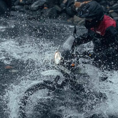 A view of a motorcyclist in water.