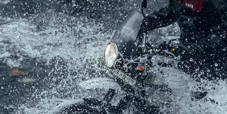 A view of a motorcyclist in water.